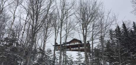 Looking up at Ilaali cottage, among the winter scenery of Le Versant du Massif.
