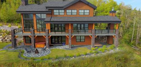 South face of Ilaali in Charlevoix. Incomparable view of the St-Lawrence River, with the fenestration on 3 levels.